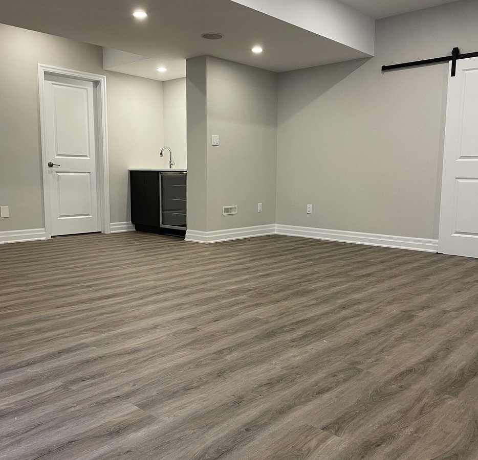 finished basement with wet bar and barn door built by Baird Construction in Woodstock ON